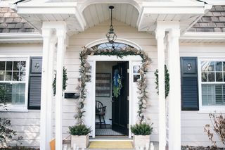 farmhouse front porch decorated for christmas