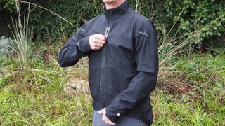 A man zipping up a waterproof Gorewear jacket