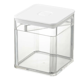 Clear food storage container with tongs.