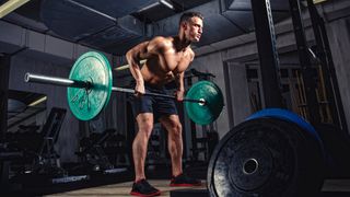 Man performs barbell bent-over row