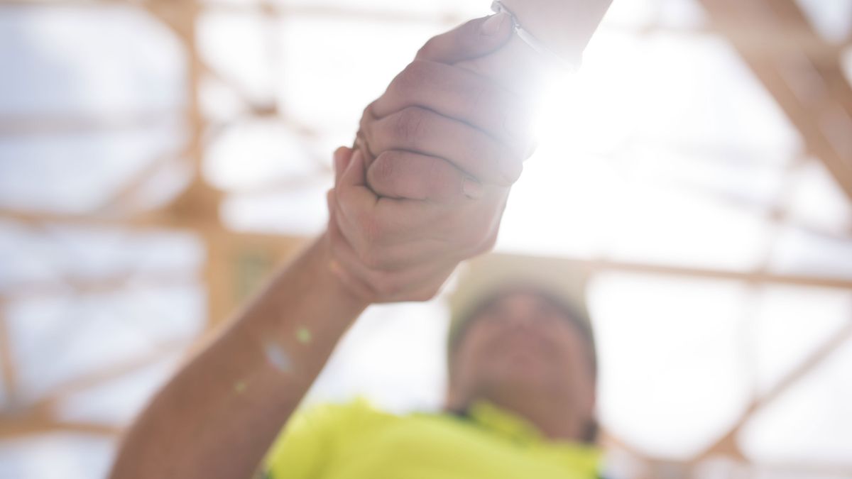 someone shaking hands with a builder