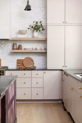 A kitchen with beige, slim style shaker cabinets