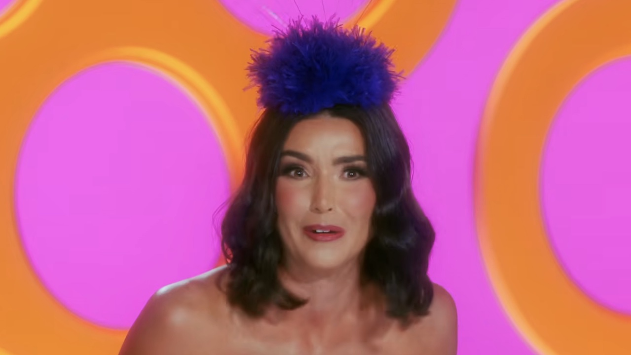 Bronwyn Newport at the judgement table in the trailer for RuPaul's Drag Race: All Stars 11.