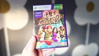 A photo of the game case for the Xbox 360 game Kinect Adventures in front of a gray wallpaper with a flower design.