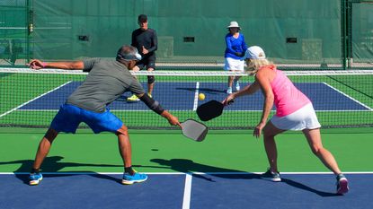 Four people playing pickleball