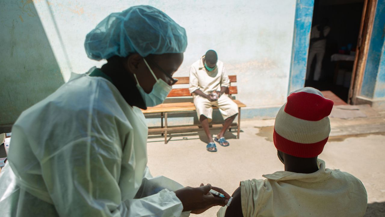 A nurse gives a Covid vaccination in Harare, Zimbabwe