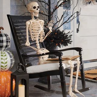 skeleton sitting in a chair