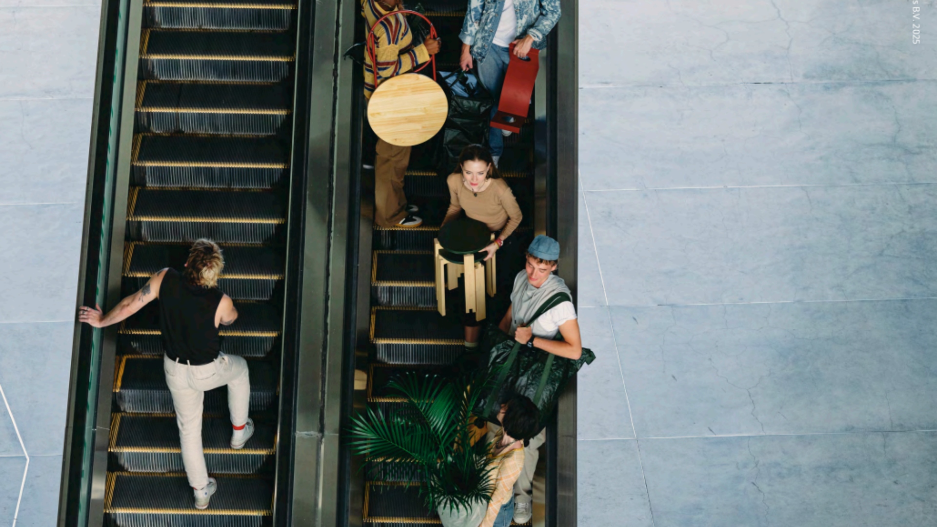 People carry IKEA's new KOMPISH&amp;Auml;NG furniture collection on an elevator