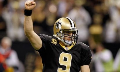 New Orleans Saints quarterback Drew Brees celebrates after throwing a nine-yard touchdown pass and breaking the single-season passing record formerly held by Dan Marino.