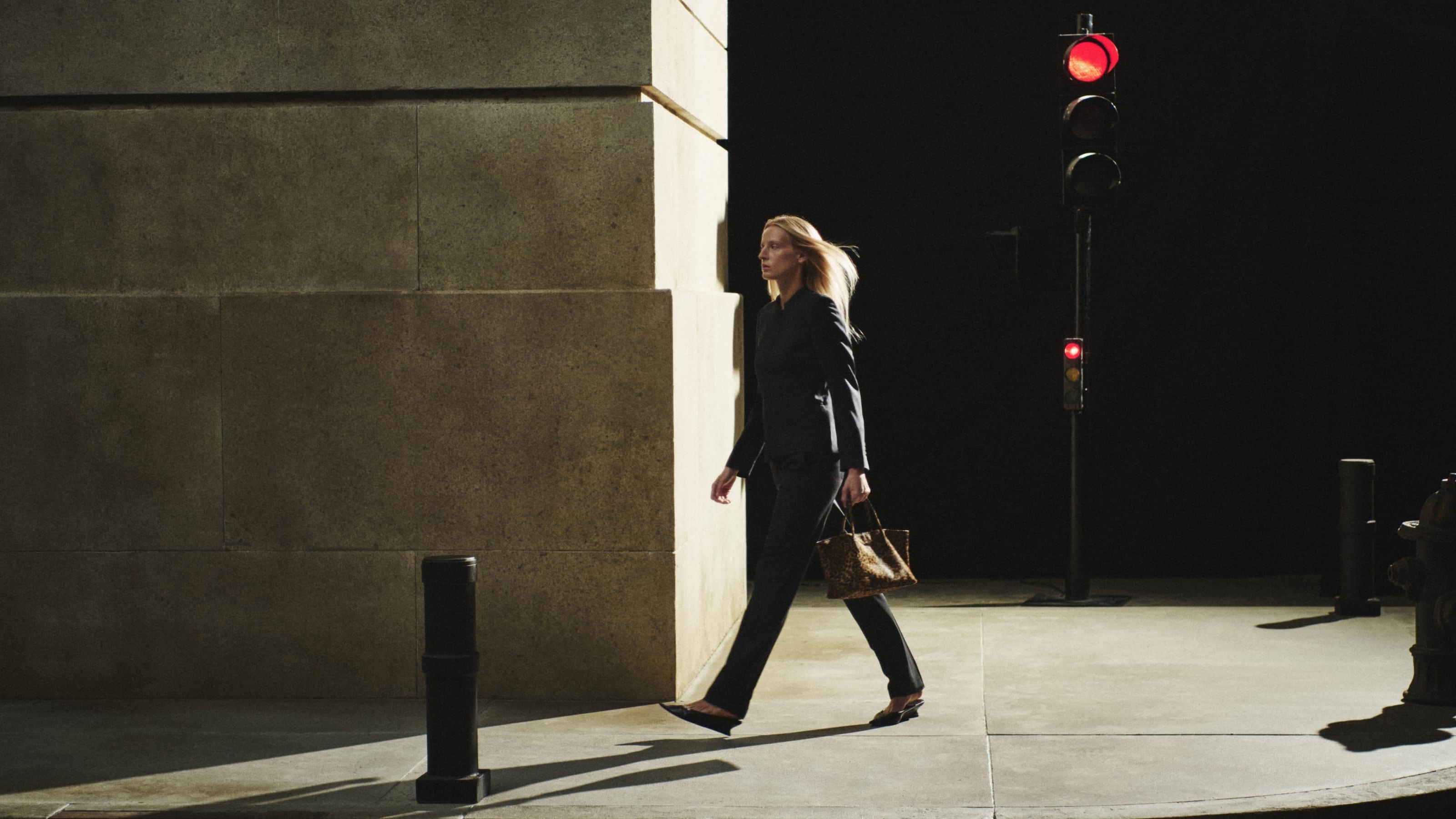 blonde woman walking through the street
