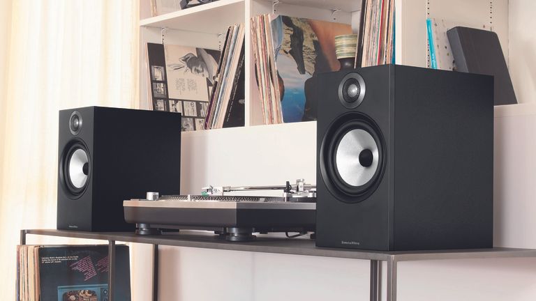 Best turntables speakers, image shows Bowers & Wilkins 606 speakers with a turntable on a shelf surrounded by records