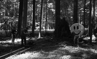 black and white image of big smiley face in a forest