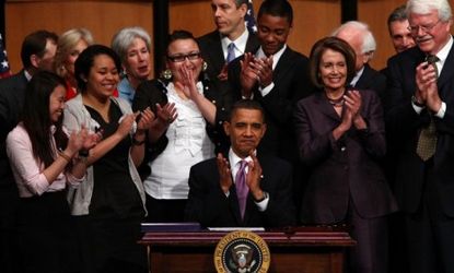 President Obama applauds after signing the health care act in 2010: The Supreme Court will assess, among other things, the controversial individual health care mandate.