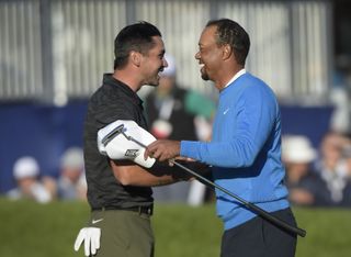 Jason Day and Tiger Woods shake hands after the first round of the Farmers Insurance Open