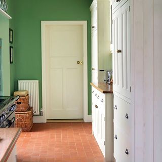 green utility room with white cabinet