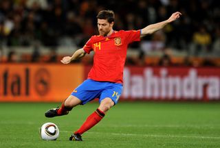 Xabi Alonso plays a pass for Spain against Portugal at the 2010 World Cup.