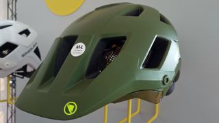 A side view of the new Endura Hummvee Plus helmet in green