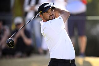 Jason Day hits a tee shot and watches it in the air