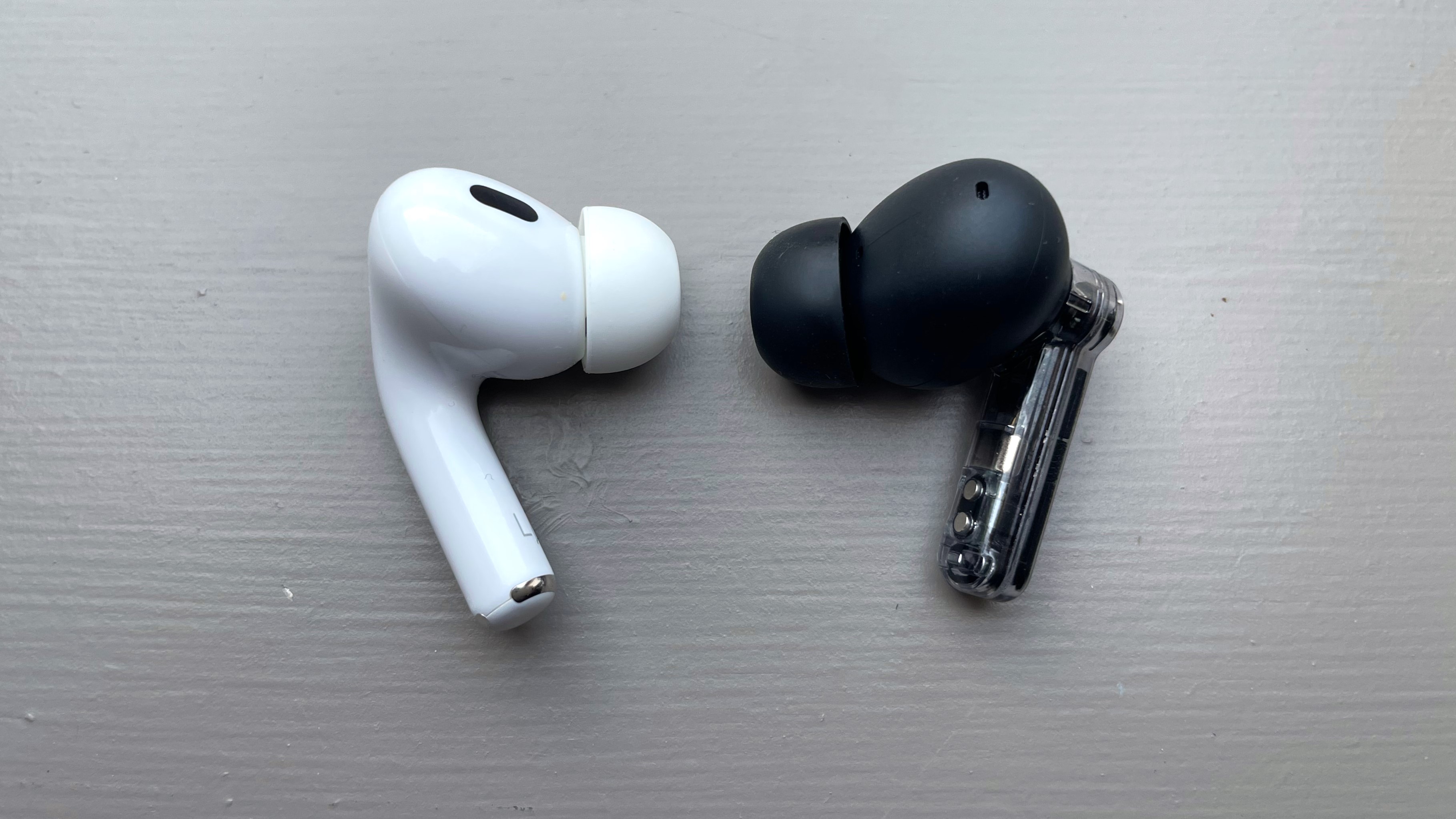 Nothing Ear and AirPods Pro 2 buds side by side