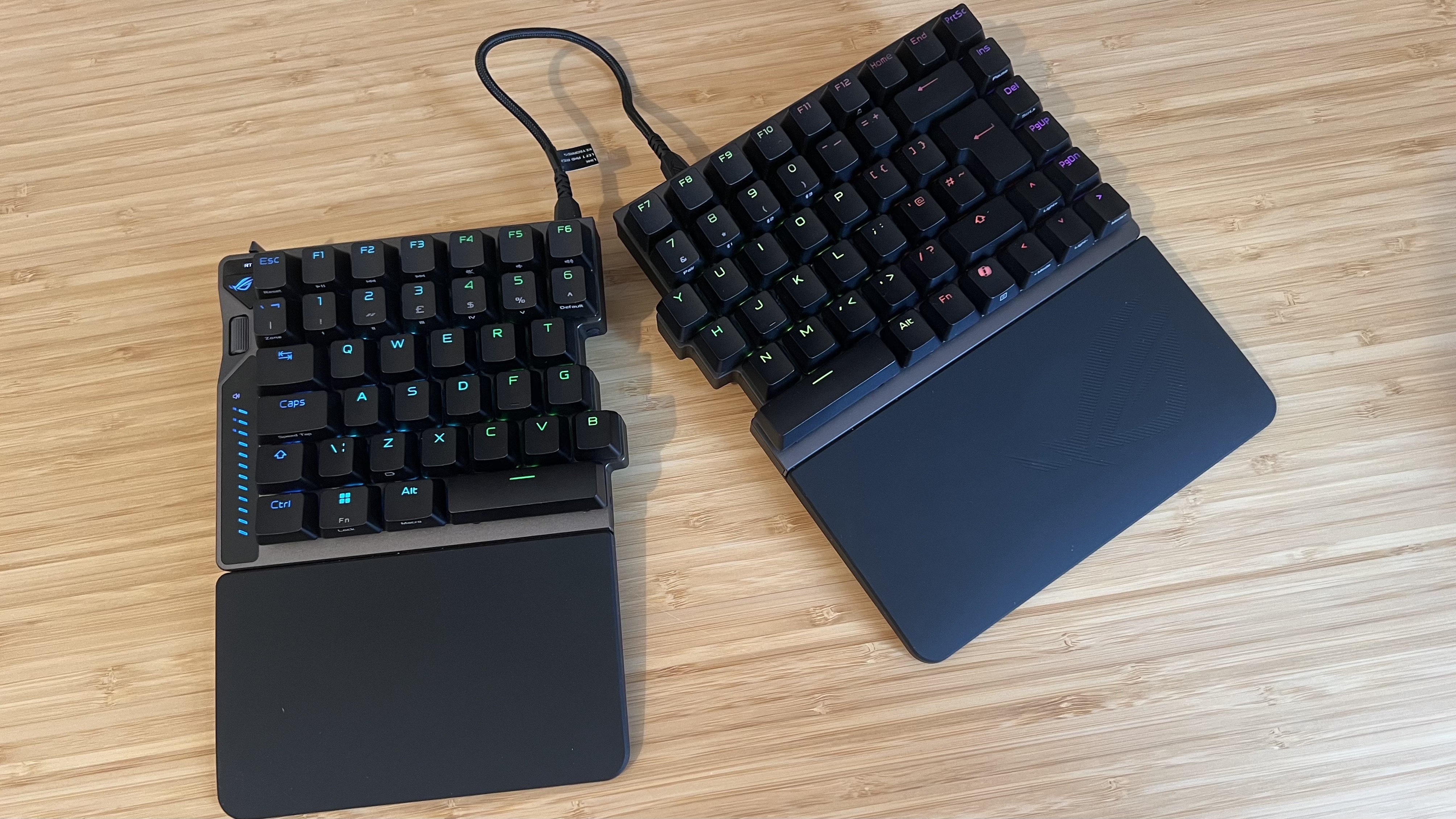 Asus ROG Falcata gaming keyboard on a wooden desk