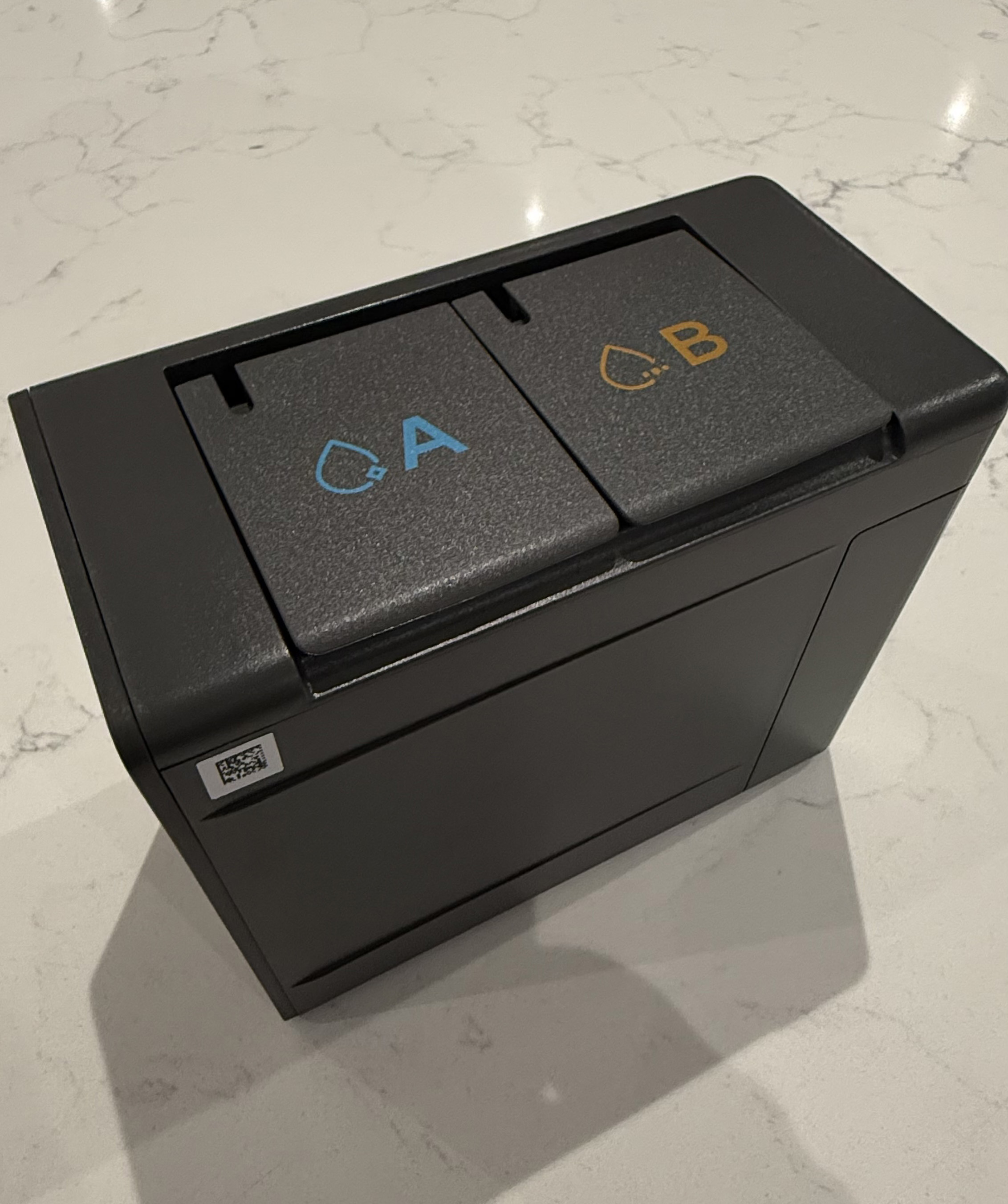 Close-up of the Dreame Aqua10 Ultra Roller dock showing dual cleaning solution reservoirs labeled A and B