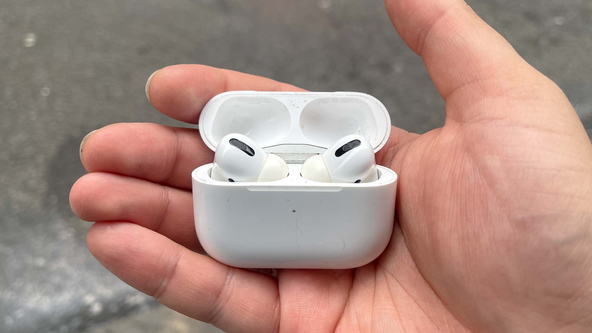 The AirPods Pro charging case being held in hand