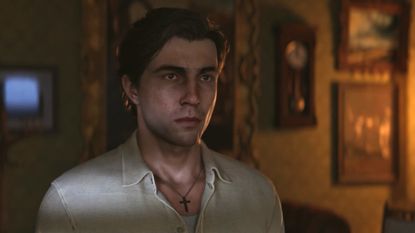 Enzo Favara in a dark room during a cut scene in Mafia: The Old Country. 