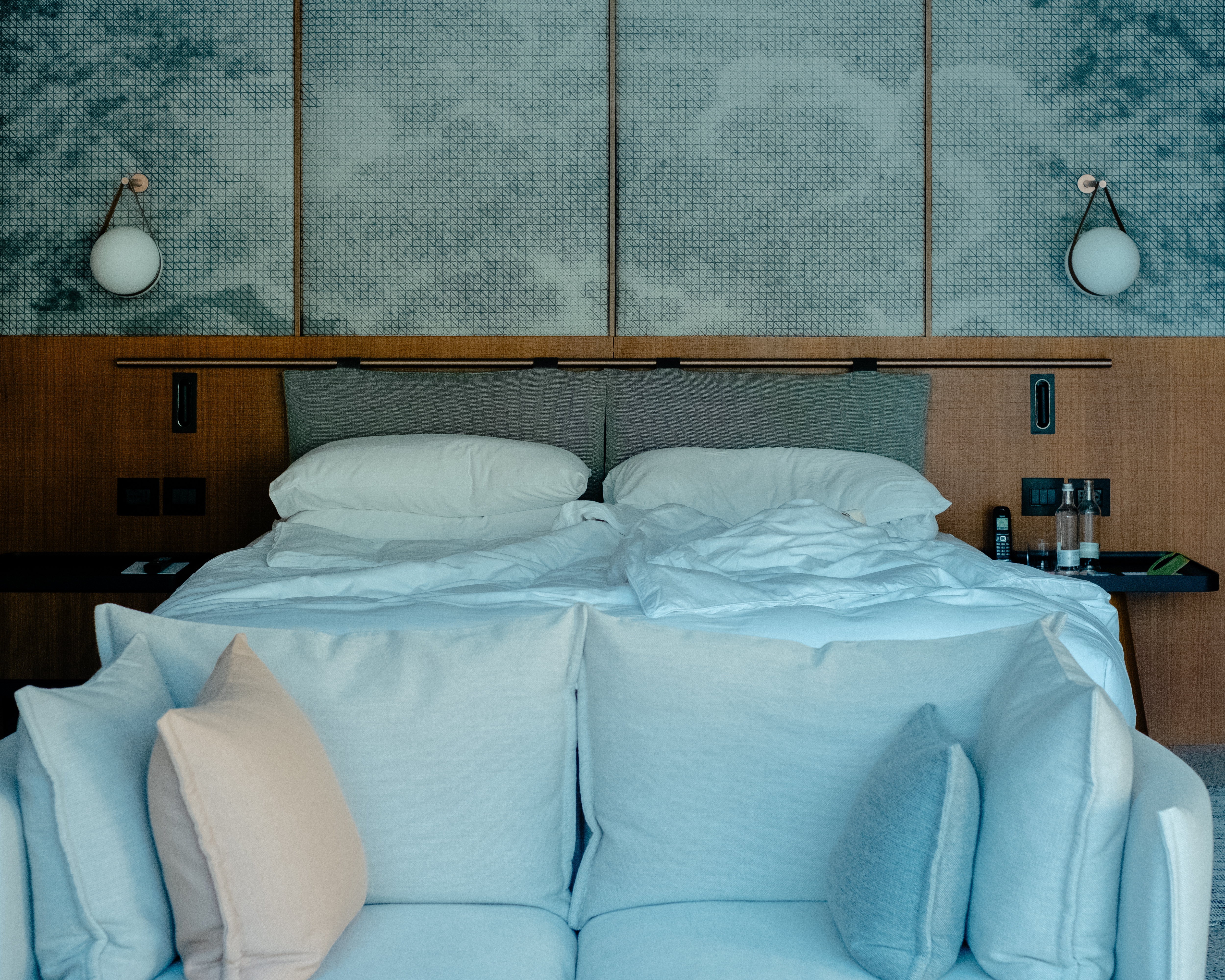 A mid-century modern-inspired hotel suite features earthy-tinted interiors, colorful design collectibles, and plenty of music equipment.