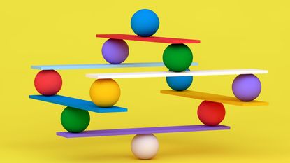 different colored balls balancing on wood slats