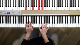 Overhead view of hands on a piano