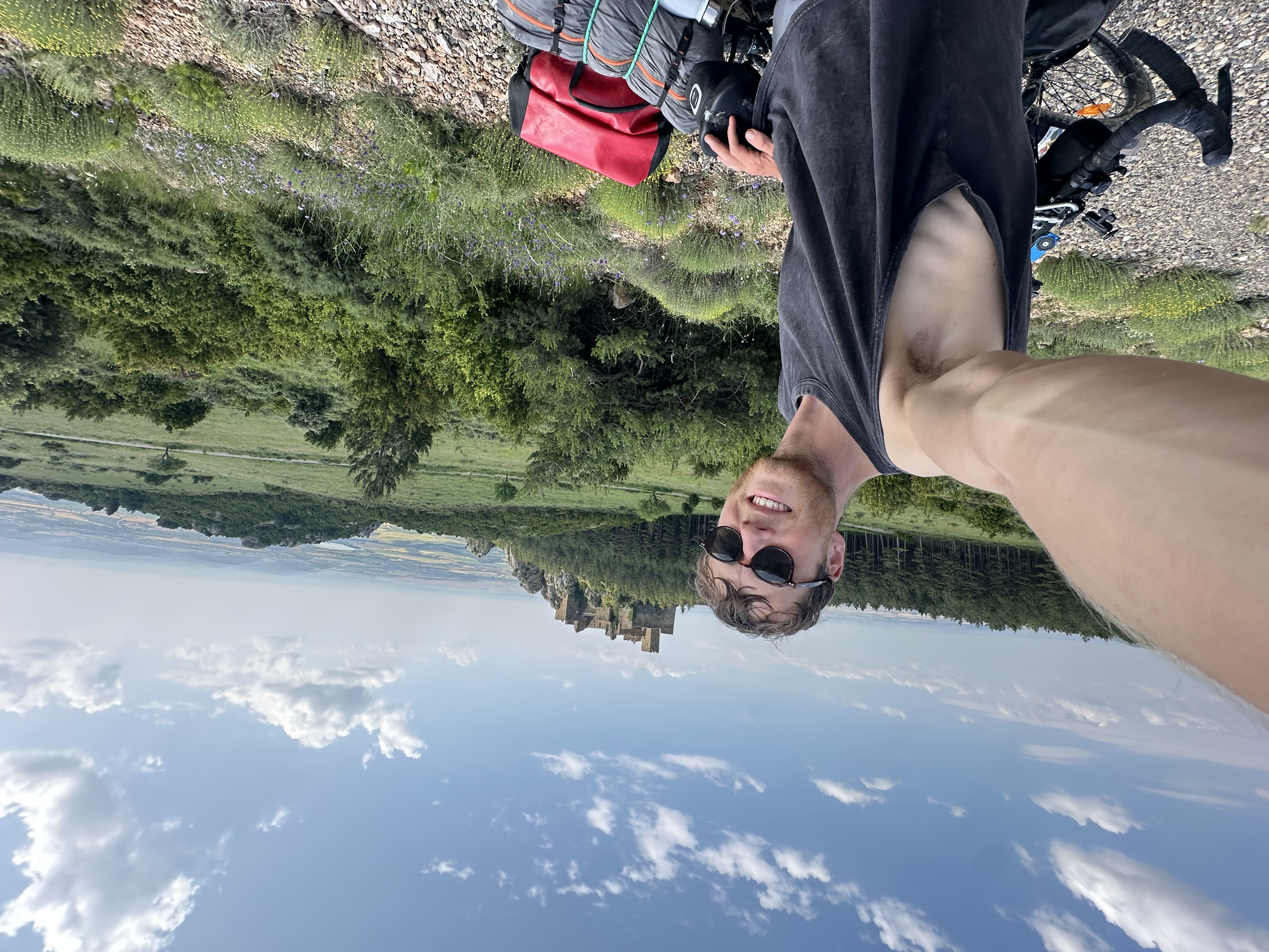 Man takes selfie on bike near castle