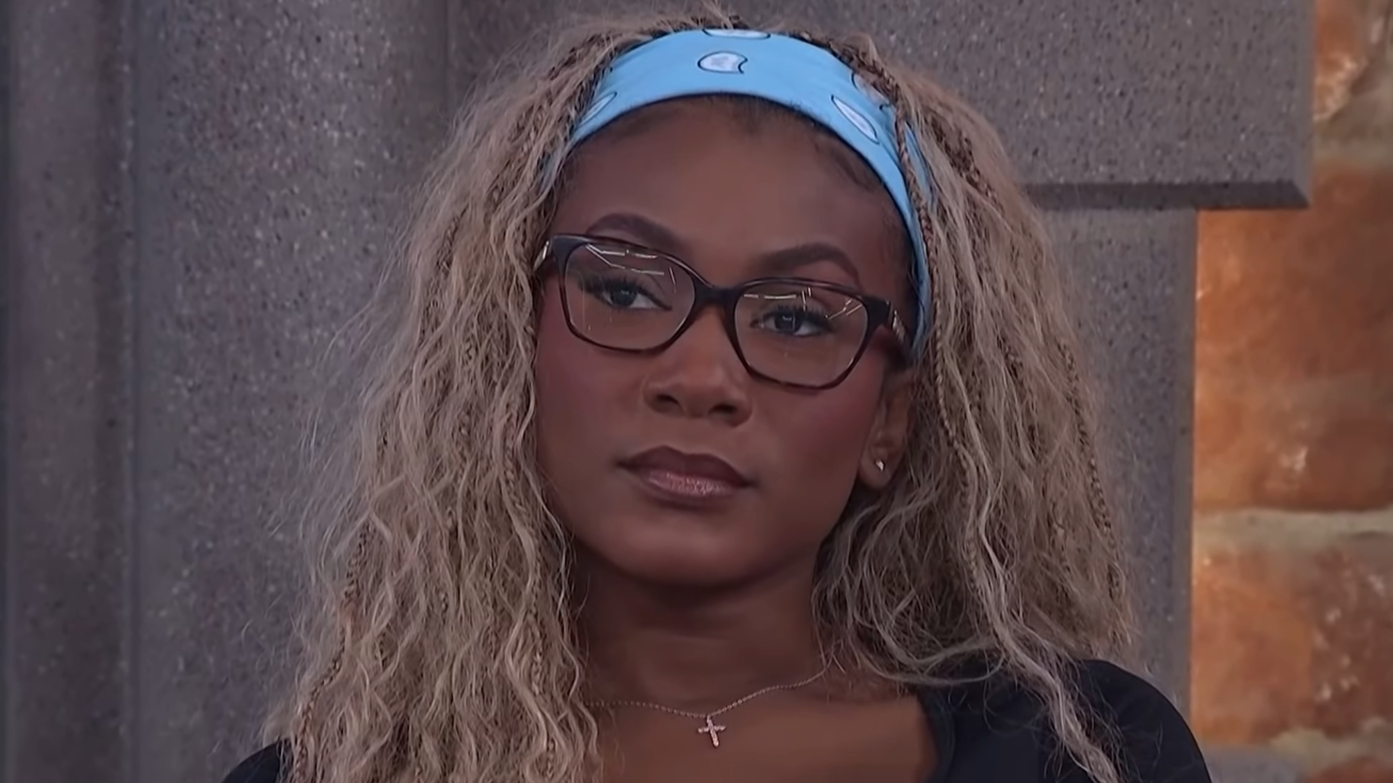 Taylor Brown stares straight ahead during a live Big Brother episode.