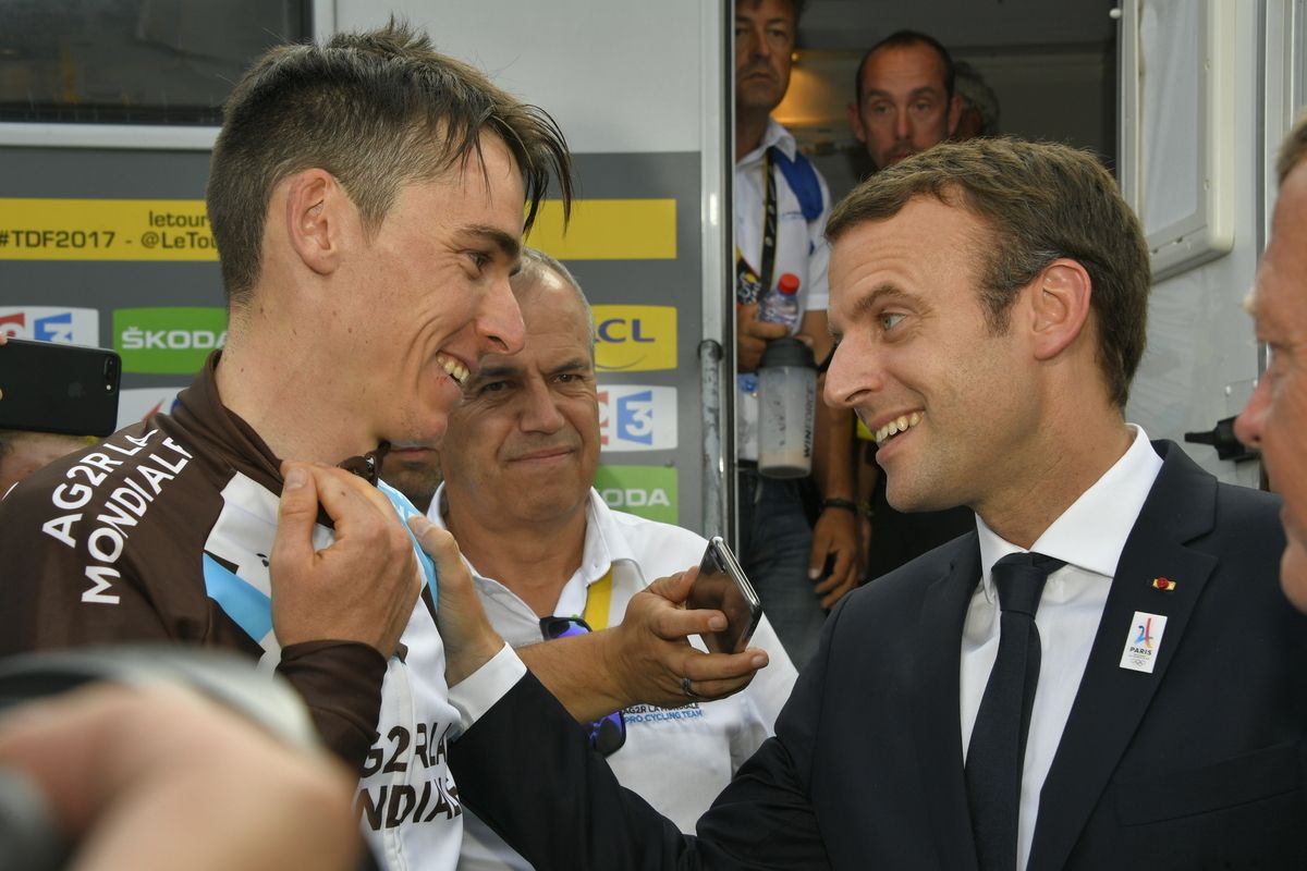 Romain Bardet and French president Emanuel Macron embrace after the Serre-Chevalier finish