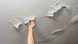 What causes dampness in a house? image shows ceiling with damp