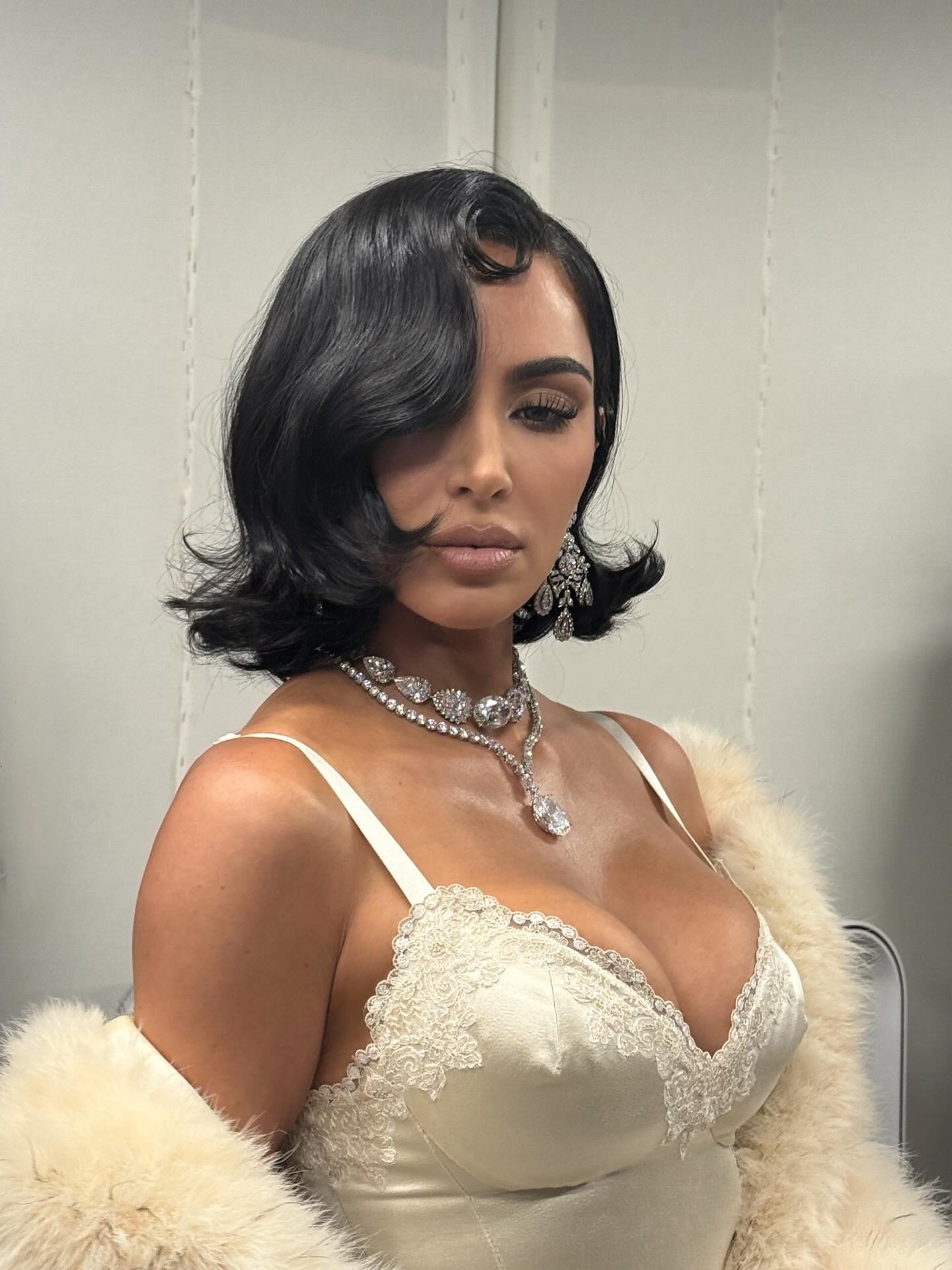 Kim Kardashian wearing a wavy bob hairstyle.