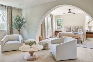 Open plan bedroom and sitting room with architectural archway detail separating the two