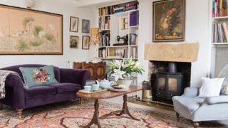 living room with purple sofa and fireplace