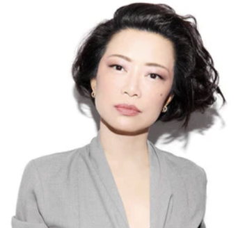 women with black hair in a gray blazer