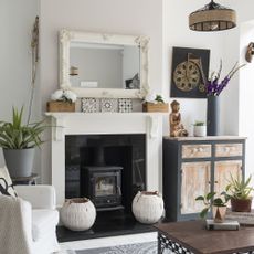 stone fireplace with black hearth with two vases as decoration