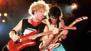 Van Halen’s Sammy Hagar and Eddie Van Halen playing guitar onstage in 1986