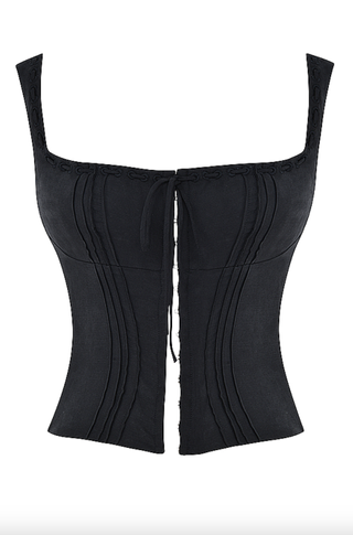 A black corset top by house of cb on a plain backdrop