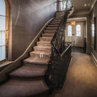 hallway with opulent walls and chandelier