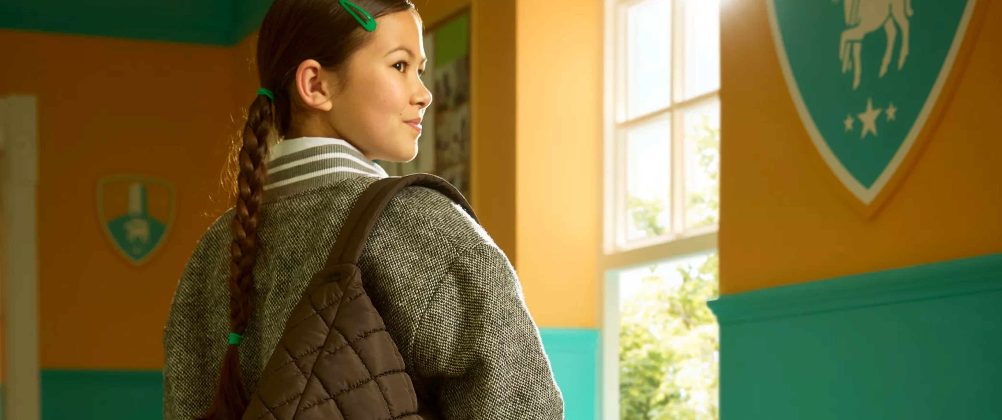Schoolgirl with a brown quilted tote bag sold at Clarks