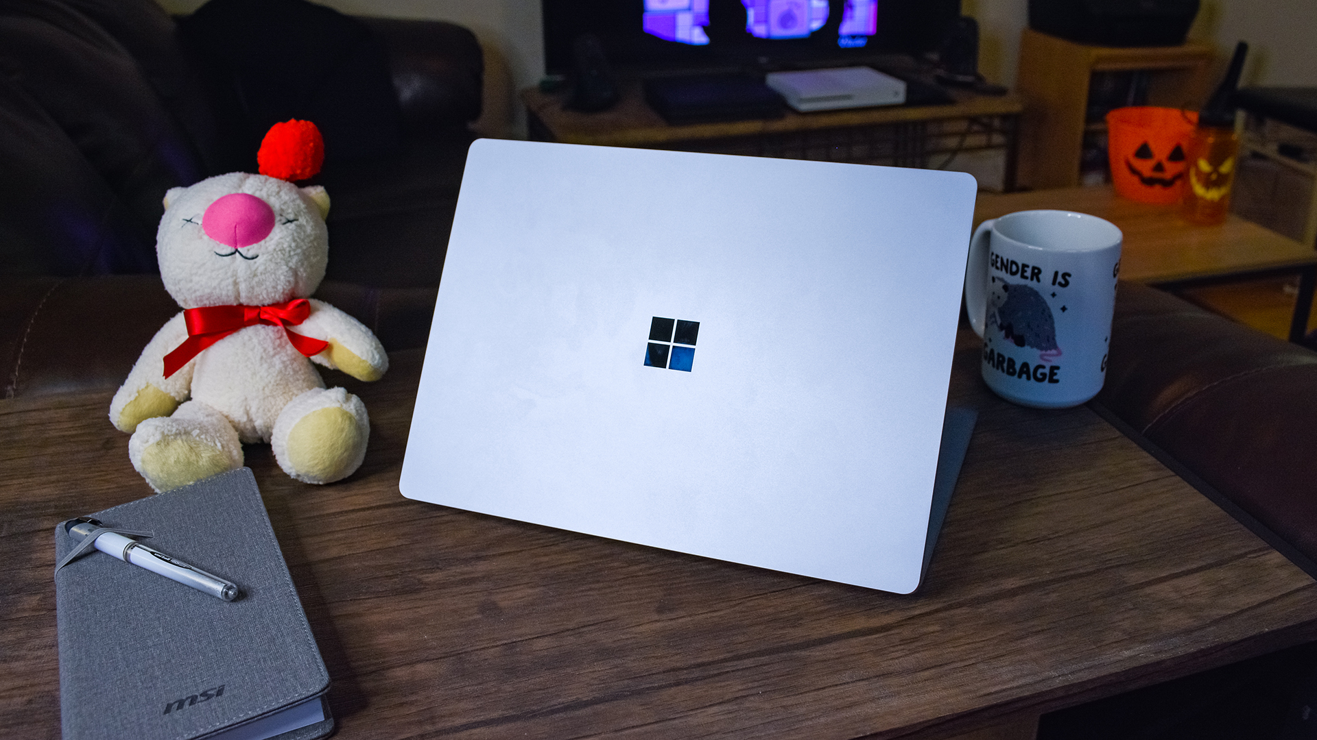 Surface Laptop 4 on a coffee table next to a notebook and a coffee cup