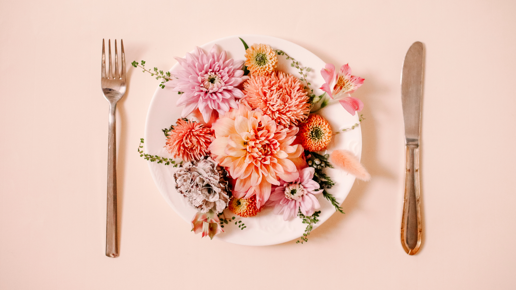 Plate of edible flowers with knife and fork