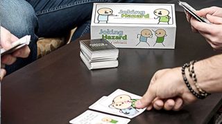 Someone places a card down on a table with a deck and the Joking Hazard box
