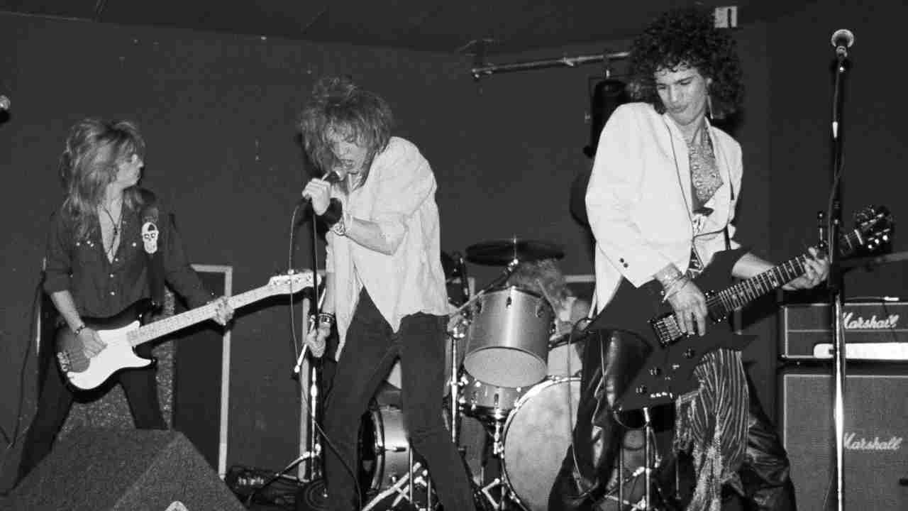 Axl Rose and Slash performing onstage with Hollywood Rose in 1984