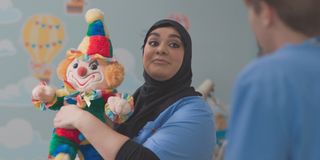 Rida playing with a toy clown in Casualty.