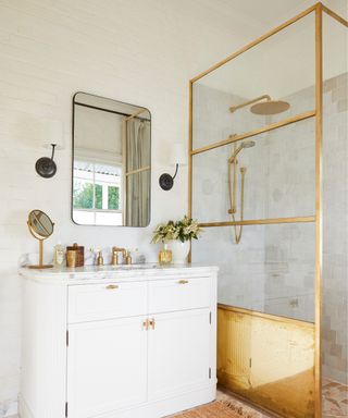 gold framed shower screen and white vanity unit