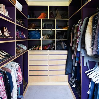 dressing room with clothes on purple shelves